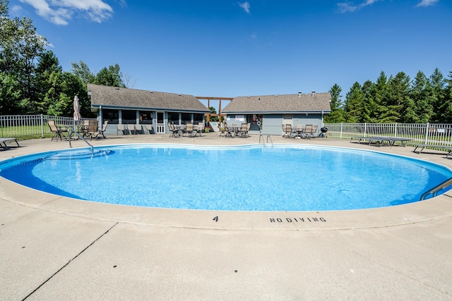 view of swimming pool with a patio and an outdoor structure