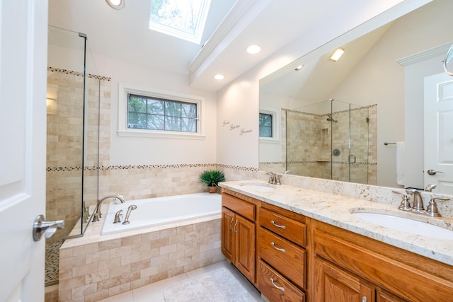 bathroom featuring tile patterned flooring, lofted ceiling with skylight, independent shower and bath, and vanity