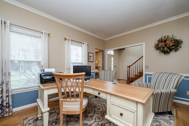 office space with ornamental molding and light wood-type flooring