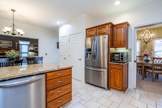 kitchen featuring stainless steel appliances, crown molding, and a notable chandelier