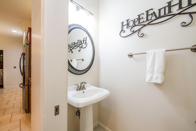 bathroom featuring sink, tile patterned flooring, and crown molding