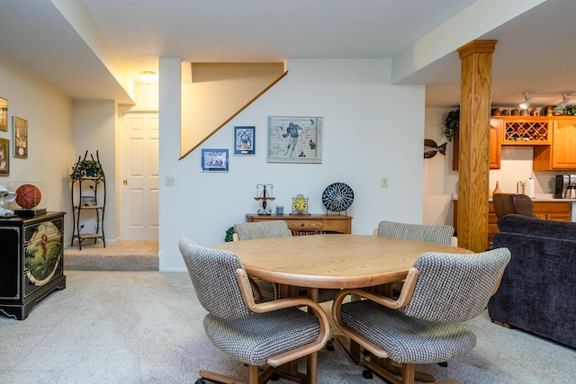 dining space featuring light carpet