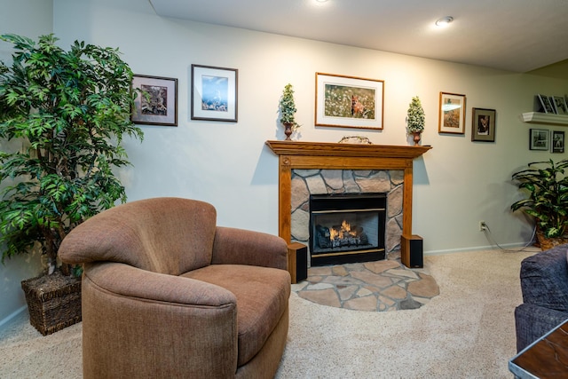 living room featuring light colored carpet and a stone fireplace