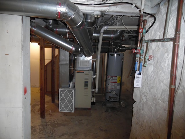 utility room featuring heating unit and gas water heater