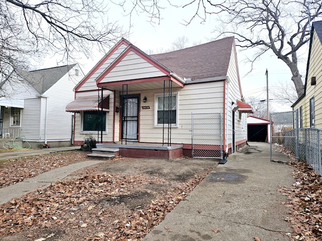 bungalow with a garage and an outdoor structure