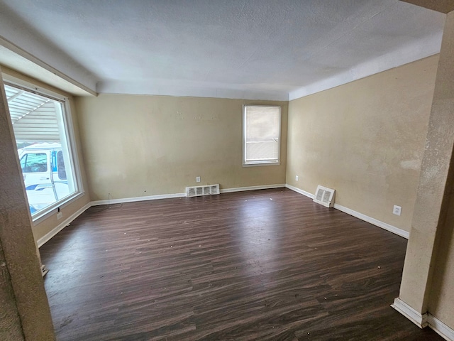 spare room featuring dark hardwood / wood-style flooring