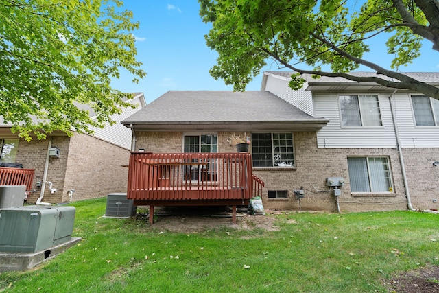 back of house with a wooden deck, cooling unit, and a lawn