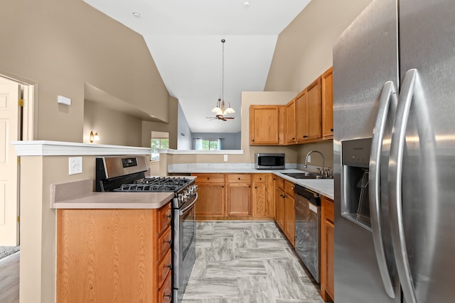 kitchen featuring sink, an inviting chandelier, stainless steel appliances, decorative light fixtures, and vaulted ceiling