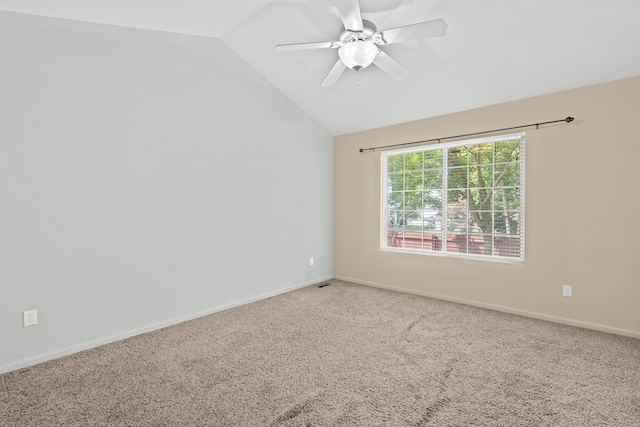 carpeted empty room featuring ceiling fan and vaulted ceiling