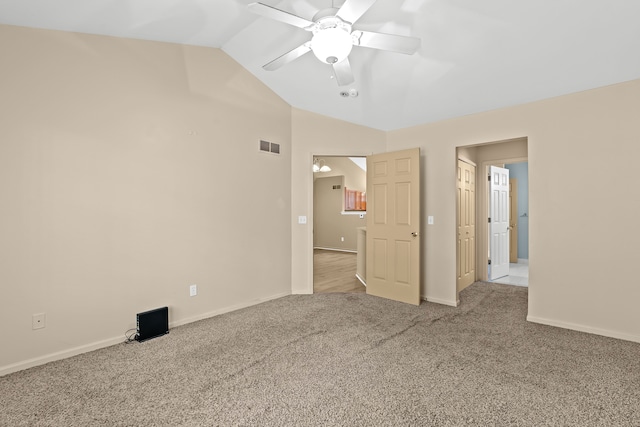 unfurnished bedroom featuring ceiling fan, vaulted ceiling, and light carpet