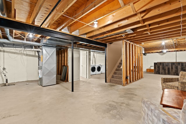 basement with heating unit and washer and dryer