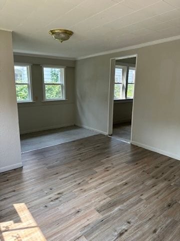 unfurnished room featuring ornamental molding and wood-type flooring