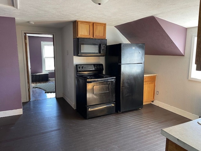 kitchen featuring a textured ceiling, radiator heating unit, black appliances, and dark hardwood / wood-style floors