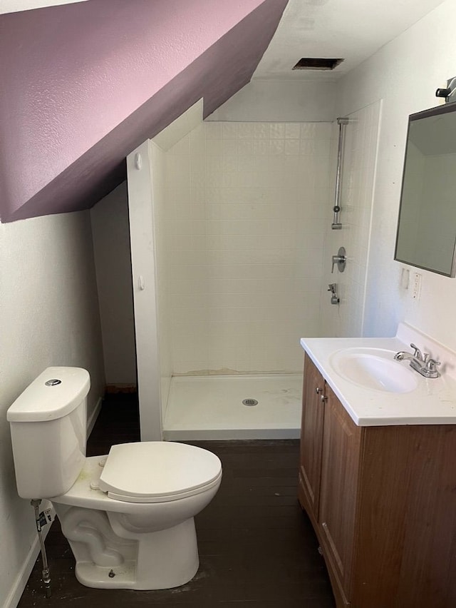 bathroom with vanity, a shower, and toilet