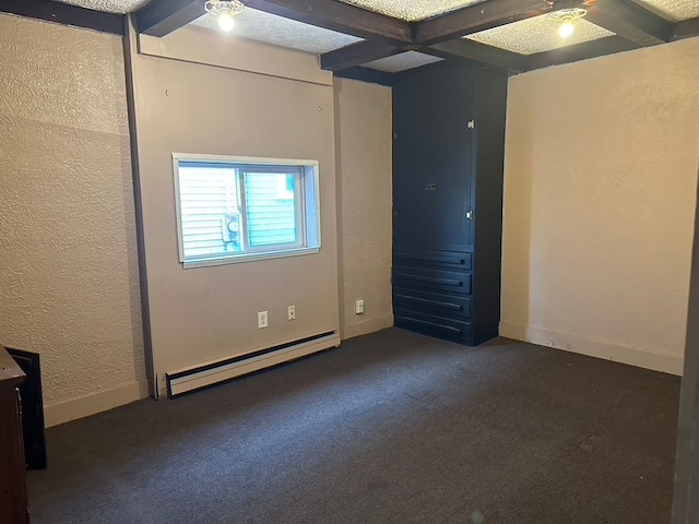 unfurnished bedroom featuring baseboard heating, beam ceiling, dark carpet, and coffered ceiling