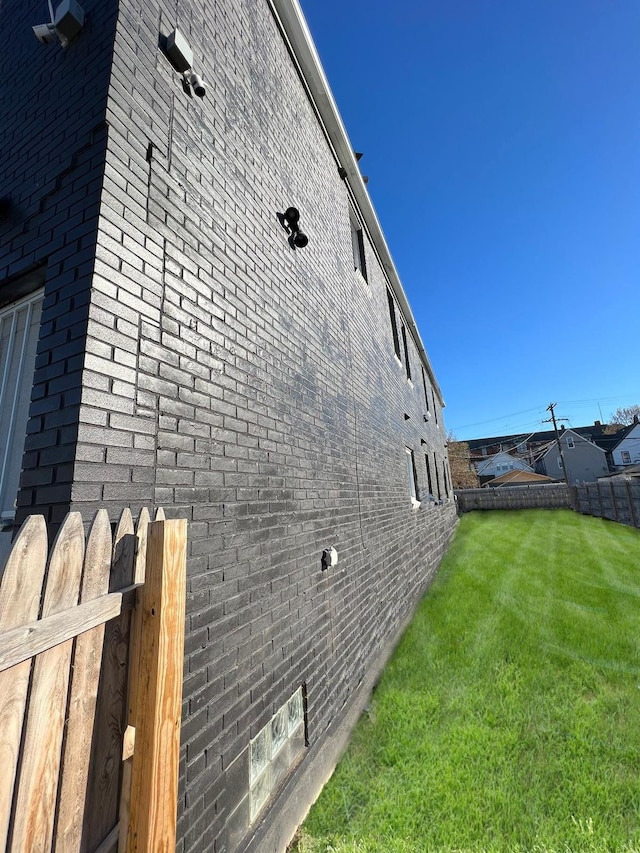 view of side of home with a lawn