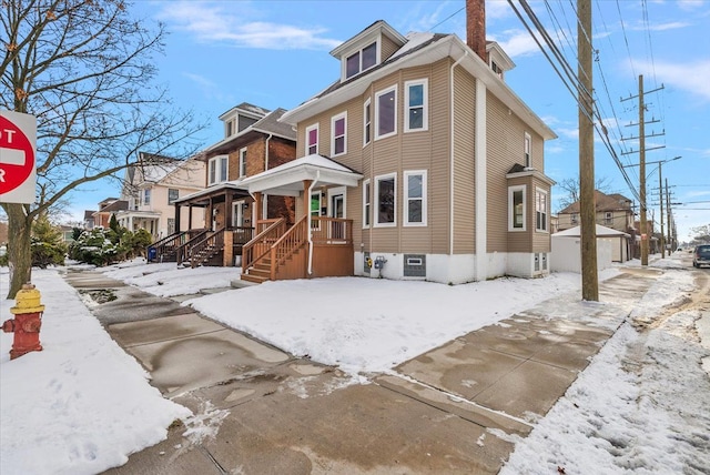 view of snow covered exterior featuring a residential view