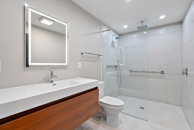 full bathroom with tiled shower, vanity, toilet, and tile patterned floors