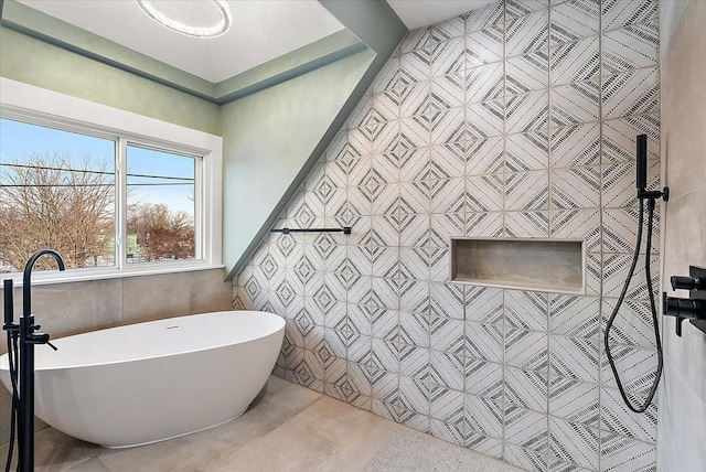 full bathroom with tile walls and a freestanding bath