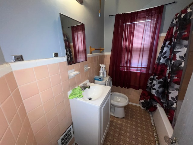 full bathroom featuring tile walls, shower / tub combo, vanity, and toilet