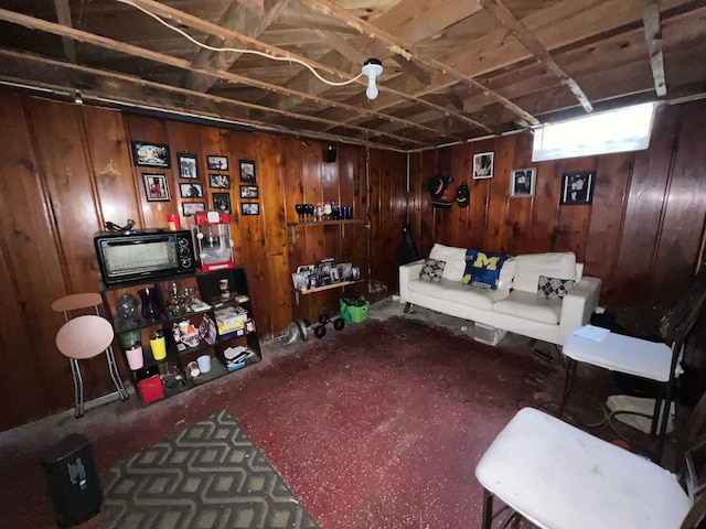 living room featuring carpet floors and wood walls