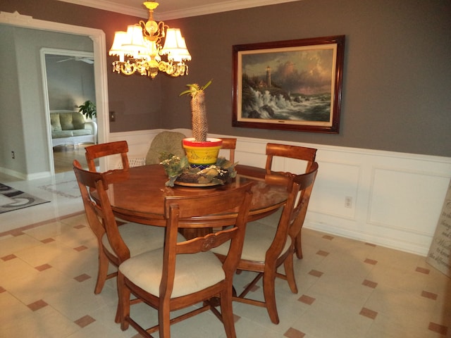 dining room featuring crown molding and a notable chandelier