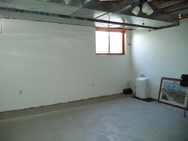 basement with a ceiling fan