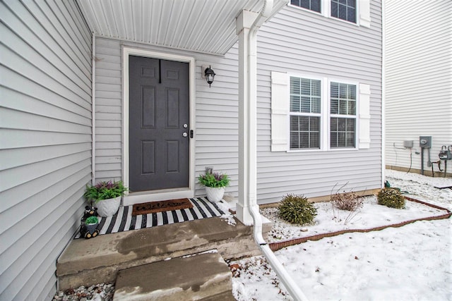 view of snow covered property entrance