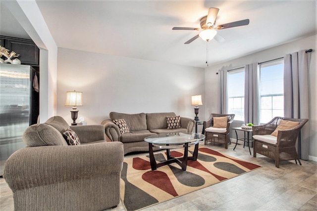 living room featuring ceiling fan and light wood-type flooring