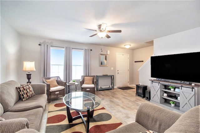 living room featuring light hardwood / wood-style floors and ceiling fan