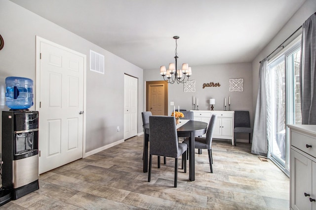 dining room featuring a chandelier and light wood-type flooring