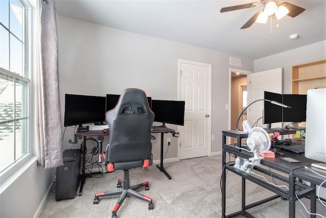 carpeted home office with ceiling fan