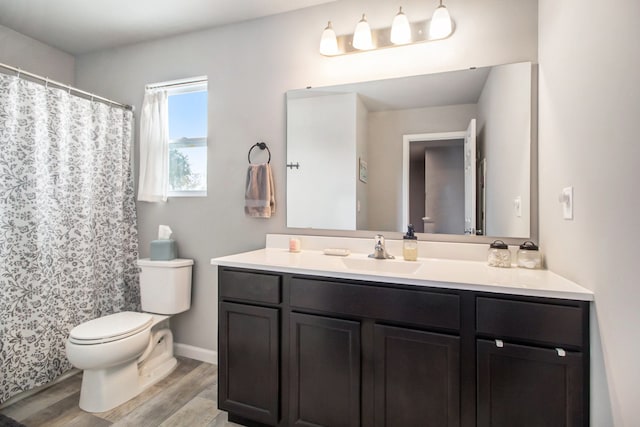 bathroom with vanity, hardwood / wood-style floors, and toilet