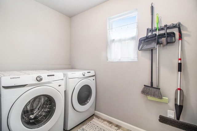 clothes washing area with separate washer and dryer