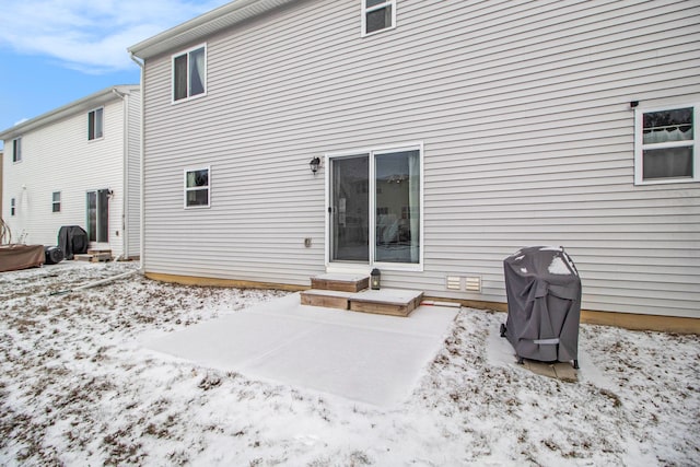 view of snow covered rear of property