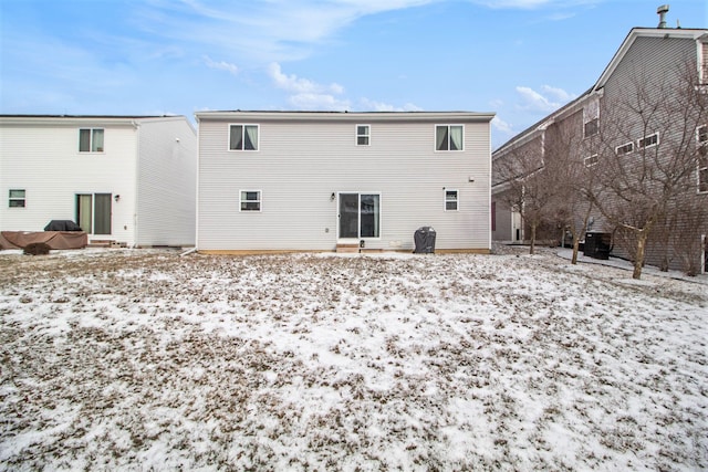 view of snow covered back of property