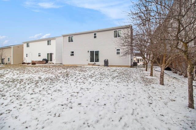 view of snow covered rear of property