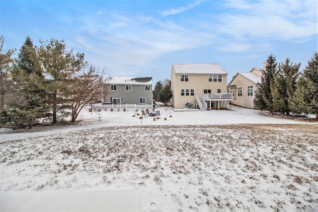 snow covered property with a deck