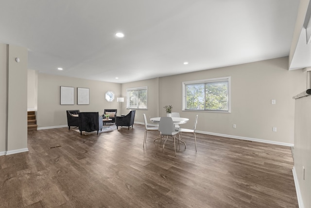 unfurnished dining area with dark wood-type flooring