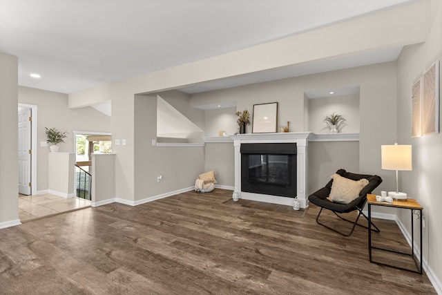 living area featuring hardwood / wood-style flooring and vaulted ceiling