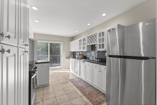 kitchen with sink, white cabinets, and appliances with stainless steel finishes