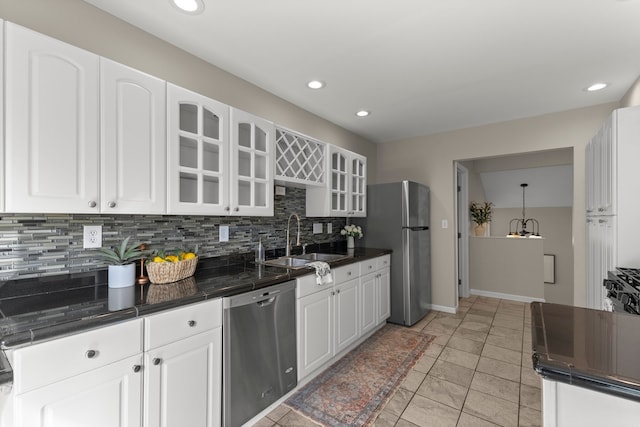 kitchen featuring sink, white cabinetry, backsplash, pendant lighting, and appliances with stainless steel finishes