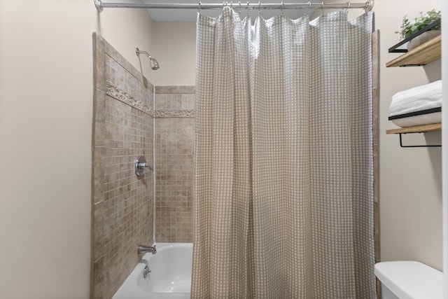 bathroom featuring toilet and shower / bath combo with shower curtain