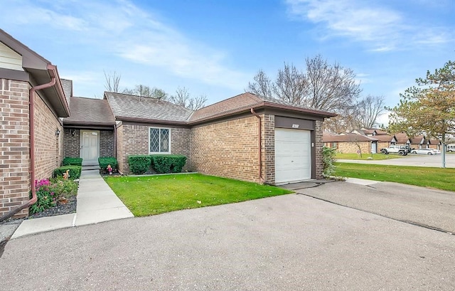 doorway to property featuring a yard and a garage