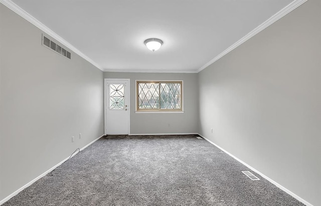 empty room featuring ornamental molding and carpet