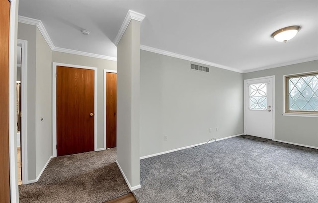 foyer entrance with carpet floors and ornamental molding