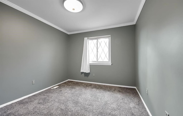 empty room with ornamental molding and carpet