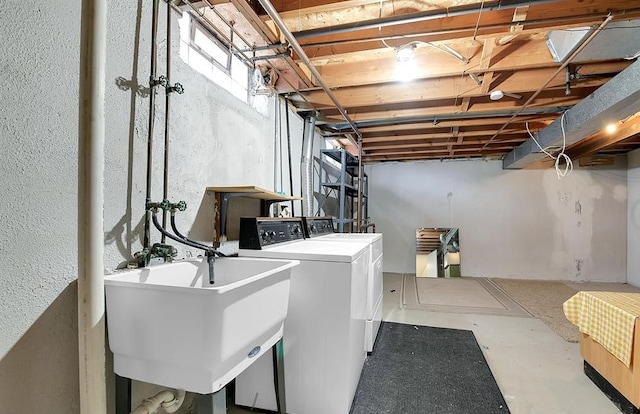 clothes washing area with sink and washing machine and clothes dryer