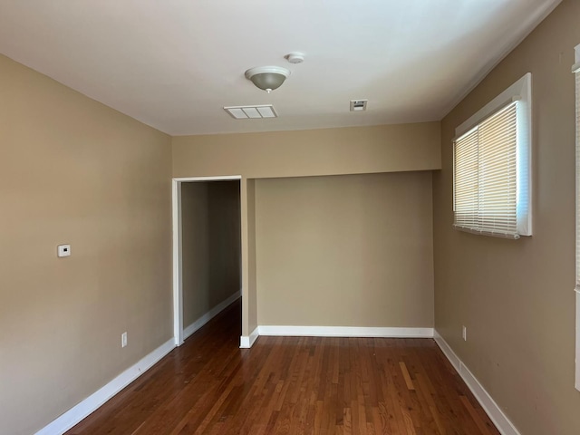 unfurnished bedroom featuring dark hardwood / wood-style floors