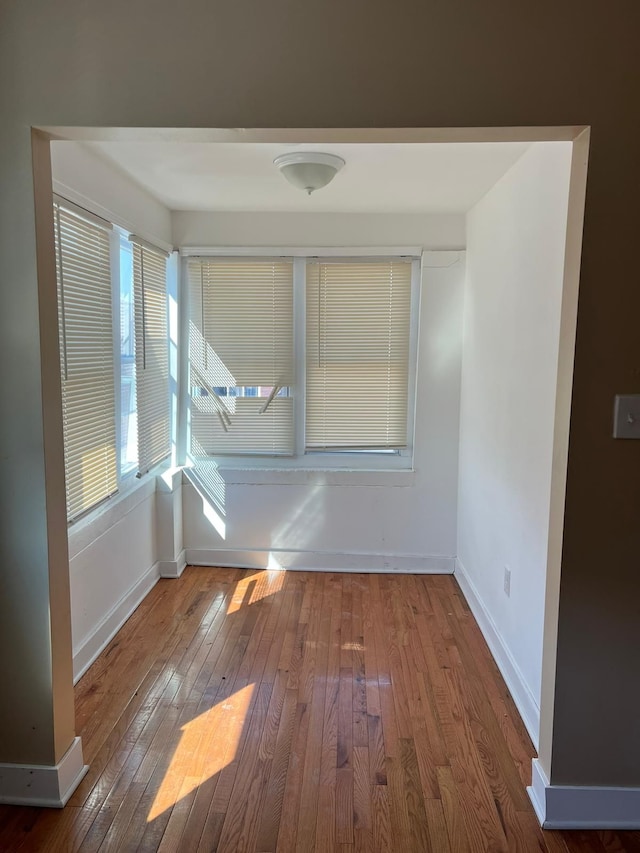 unfurnished room with wood-type flooring